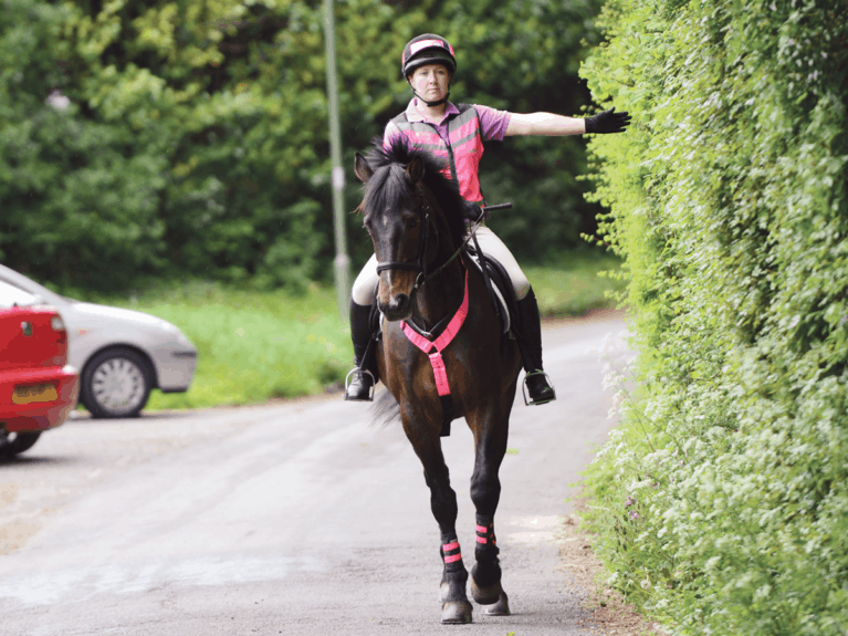 Rider giving arm signals to drivers