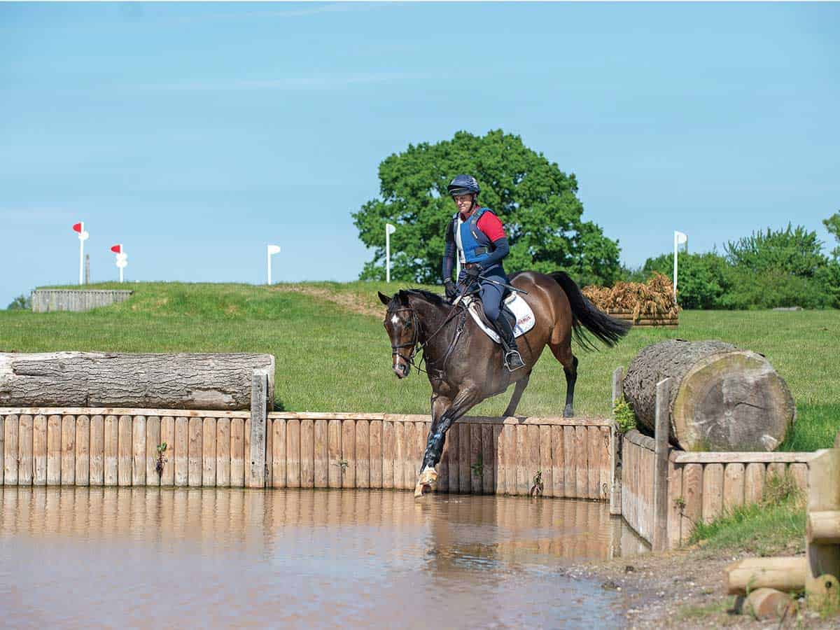 Tina Cook jumping into a cross-country water jump