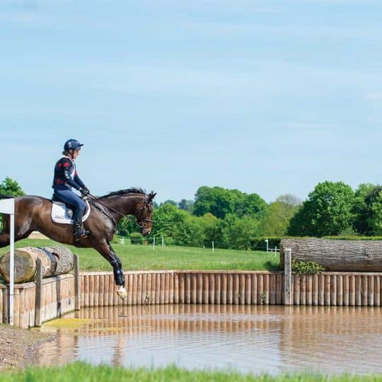 Tina Cook jumping in to a water jump