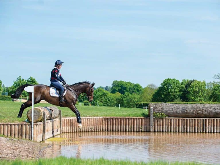 Tina Cook jumping in to a water jump