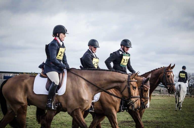 Eventing, three riders at an event walking together to a warm up